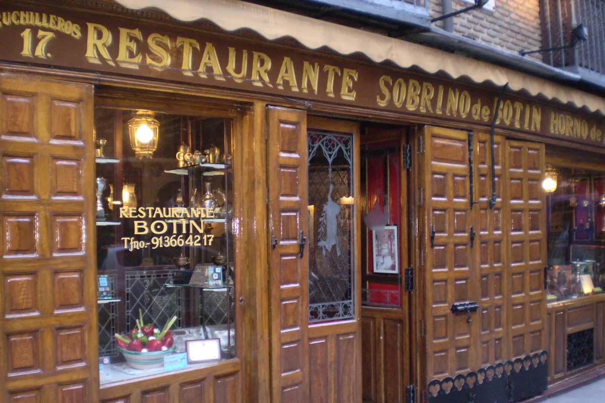 The carved wooden storefront of Sobrino de Botín, the world's oldest restaurant, in central Madrid